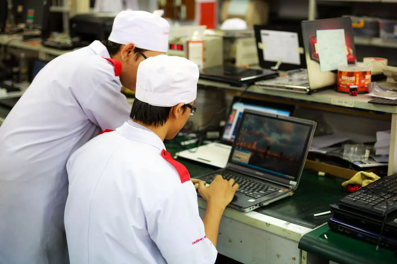 Frostlark technicians collaborating on a complex hardware repair task